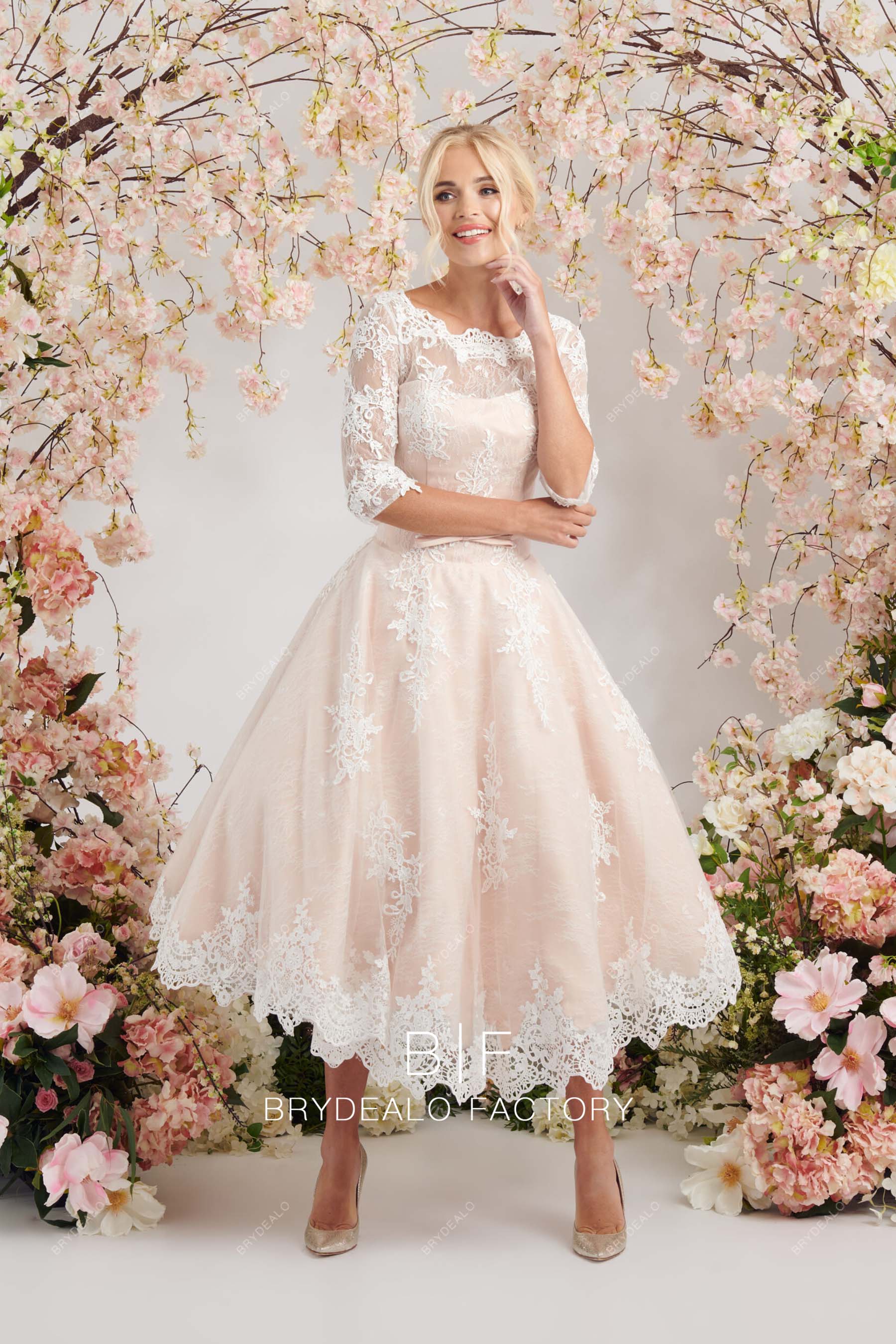 lace blush A-line sleeved wedding gown