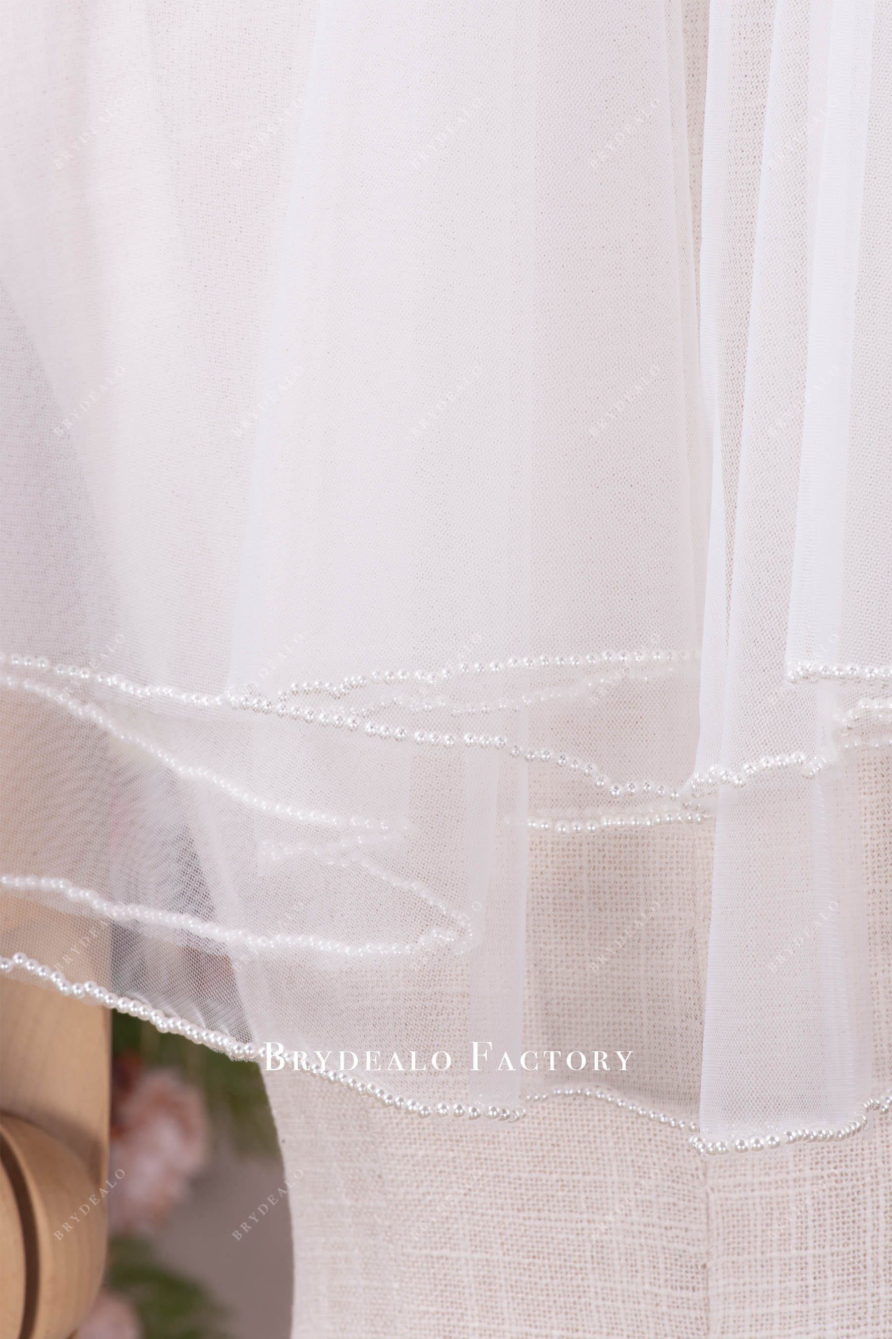 delicate hand-sewn pearl edge veil